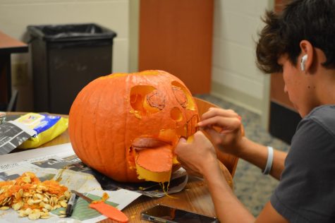 Students carve pumpkins as Halloween nears