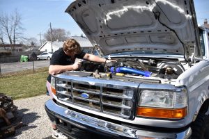 Amateur mechanics rolling up their sleeves