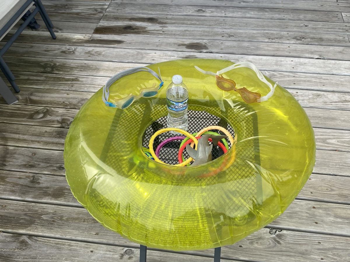 Senior assassin tools such as a water bottle, pool floaties, pool toys, and goggles are set on display. These tools are utilized to attack students and protect themselves from being eliminated from the game. Zoe Corn photo.